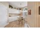 Charming breakfast nook with built-in cabinets, a pendant light, and a view to the outside at 6314 Stone River Rd # 6314, Bradenton, FL 34203