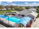 Resort-style pool with lounge chairs and shade structures at community recreation center at 6314 Stone River Rd # 6314, Bradenton, FL 34203