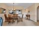 Open dining area with wooden table set, decorative chandelier, and seamless flow into the kitchen and living space at 6314 Stone River Rd # 6314, Bradenton, FL 34203