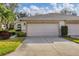 Spacious two-car garage with a clean driveway and manicured landscaping, offering convenience and curb appeal at 6314 Stone River Rd # 6314, Bradenton, FL 34203