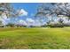Scenic golf course view with mature trees and well-manicured lawns under a partly cloudy sky at 6314 Stone River Rd # 6314, Bradenton, FL 34203