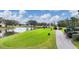 Beautiful golf course with a lake, golfers, a golf cart, and lush green fairways under a blue sky at 6314 Stone River Rd # 6314, Bradenton, FL 34203
