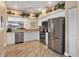 Bright kitchen with modern stainless steel appliances, wood floors, and ample counter space at 6314 Stone River Rd # 6314, Bradenton, FL 34203