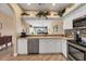 Eat-in kitchen featuring white cabinets, stainless steel appliances, and pass-through to the dining room at 6314 Stone River Rd # 6314, Bradenton, FL 34203