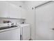 Functional laundry room featuring modern washer and dryer units, ample storage cabinets, and a convenient layout at 6314 Stone River Rd # 6314, Bradenton, FL 34203