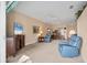 Cozy living room featuring comfortable blue recliners, a ceiling fan, and an open floor plan connecting to the dining area at 6314 Stone River Rd # 6314, Bradenton, FL 34203