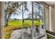 Screened-in patio with comfortable seating, potted plants, and views of golf course at 6314 Stone River Rd # 6314, Bradenton, FL 34203