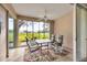 Enclosed patio featuring a dining table set and scenic golf course views at 6314 Stone River Rd # 6314, Bradenton, FL 34203