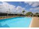 Community pool with inviting clear water, lounge chairs, and blue sky providing the ultimate relaxation at 6314 Stone River Rd # 6314, Bradenton, FL 34203