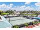 Overhead view of tennis courts with a community pool and palm trees in a scenic view at 6314 Stone River Rd # 6314, Bradenton, FL 34203