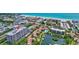 Aerial view of condo overlooking beach and inter-coastal waterway, with amenities including tennis courts, docks, and pools at 6415 Midnight Pass Rd # 211, Sarasota, FL 34242