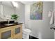 Powder room featuring modern vanity with black countertop and artistic decor at 6415 Midnight Pass Rd # 211, Sarasota, FL 34242