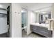 Bathroom featuring a double vanity, large mirror, and walk-in closet with modern tiling and fixtures for a clean, functional design at 6415 Midnight Pass Rd # 211, Sarasota, FL 34242