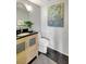 Powder room featuring modern vanity with black countertop and artistic decor at 6415 Midnight Pass Rd # 211, Sarasota, FL 34242