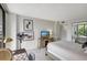 Bright bedroom with a TV, desk, closet and a window-filled balcony at 6415 Midnight Pass Rd # 211, Sarasota, FL 34242