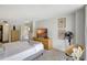 Well-lit bedroom with a TV, patterned decor, and a view into the closet at 6415 Midnight Pass Rd # 211, Sarasota, FL 34242