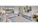 Bright bedroom with TV, twin beds, and balcony access at 6415 Midnight Pass Rd # 211, Sarasota, FL 34242