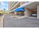 View of condo building entrance featuring a covered awning, secure entry, parking and accessible entrance at 6415 Midnight Pass Rd # 211, Sarasota, FL 34242