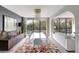Bright dining room featuring modern chandelier, colorful rug, floor to ceiling windows, and balcony access at 6415 Midnight Pass Rd # 211, Sarasota, FL 34242