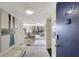 Inviting condo entryway with neutral decor leads to a bright living space, offering a glimpse of the beautiful view at 6415 Midnight Pass Rd # 211, Sarasota, FL 34242