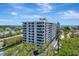 Beautiful condo building with balconies, and lush landscaping at 6415 Midnight Pass Rd # 211, Sarasota, FL 34242