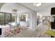 Bright living room with an open floor plan, chandelier, and large windows with balcony access at 6415 Midnight Pass Rd # 211, Sarasota, FL 34242