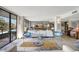 Bright living room featuring large windows, modern furniture, and access to a balcony at 6415 Midnight Pass Rd # 211, Sarasota, FL 34242