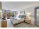 Bright main bedroom with balcony access, area rug, and decor at 6415 Midnight Pass Rd # 211, Sarasota, FL 34242