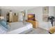 Well-lit main bedroom featuring a TV, closet access, and a comfortable bed at 6415 Midnight Pass Rd # 211, Sarasota, FL 34242