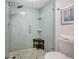 Bathroom shower featuring pebble tile and glass doors at 6415 Midnight Pass Rd # 211, Sarasota, FL 34242