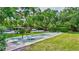 Outdoor shuffleboard court surrounded by lush greenery at 6415 Midnight Pass Rd # 211, Sarasota, FL 34242