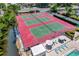 Aerial view of tennis courts and lounge area overlooking waterfront at 6415 Midnight Pass Rd # 211, Sarasota, FL 34242