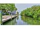 Waterfront view showcasing a canal with lush greenery and serene waters near the building at 6415 Midnight Pass Rd # 211, Sarasota, FL 34242
