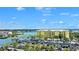 Beautiful aerial view featuring the marina and the building, set against a blue sky at 6415 Midnight Pass Rd # 910, Sarasota, FL 34242
