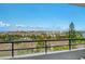 Balcony view of the community's lake, pools, and buildings at 6415 Midnight Pass Rd # 910, Sarasota, FL 34242