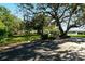 Outdoor basketball hoop next to a community green space near mature shade trees at 6415 Midnight Pass Rd # 910, Sarasota, FL 34242