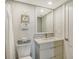 Cozy bathroom featuring a vanity with elegant fixtures, a toilet, and charming beach-themed decor at 6415 Midnight Pass Rd # 910, Sarasota, FL 34242