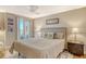 Comfortable bedroom featuring a ceiling fan and sliding glass doors that provide access to the balcony at 6415 Midnight Pass Rd # 910, Sarasota, FL 34242