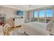 Bright bedroom featuring a dresser, balcony access, and a ceiling fan at 6415 Midnight Pass Rd # 910, Sarasota, FL 34242