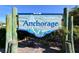 Charming sign for The Anchorage community entrance, featuring a sailboat and anchor design at 6415 Midnight Pass Rd # 910, Sarasota, FL 34242