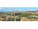 Community view with a lake, pools, buildings, and a beach in the distance at 6415 Midnight Pass Rd # 910, Sarasota, FL 34242