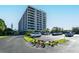 Modern condo building with well maintained landscaping and plentiful parking at 6415 Midnight Pass Rd # 910, Sarasota, FL 34242