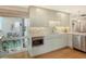 Modern kitchen featuring sleek white cabinets, stainless steel appliances, and access to a bright, airy balcony at 6415 Midnight Pass Rd # 910, Sarasota, FL 34242