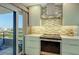 Modern kitchen with electric range and adjacent balcony at 6415 Midnight Pass Rd # 910, Sarasota, FL 34242