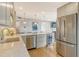 Bright kitchen featuring stainless steel appliances, a wine cooler, and a marble countertop island at 6415 Midnight Pass Rd # 910, Sarasota, FL 34242