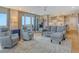 Contemporary living room with recliner chairs and balcony access at 6415 Midnight Pass Rd # 910, Sarasota, FL 34242