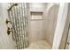 Elegant shower with bronze fixtures, mosaic tile accents, and a convenient built-in shelf at 6415 Midnight Pass Rd # 910, Sarasota, FL 34242