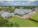 An aerial shot shows the building with the roof, golf course, parking area, and beautiful landscape at 6916 Stoneywalk Ct # 6916, Bradenton, FL 34203