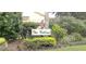 Welcoming entrance sign to The Villas, surrounded by well-maintained landscaping and American flags at 6916 Stoneywalk Ct # 6916, Bradenton, FL 34203