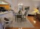 Elegant dining room with a glass-top table, chandelier, and views into the living room is perfect for entertaining at 6916 Stoneywalk Ct # 6916, Bradenton, FL 34203